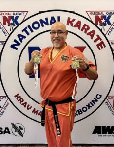 Carlos Lopez holding tournament medals